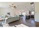 Open-concept living area with modern furnishings, wood floors, and seamless flow to kitchen and dining at 7772 Sw 146Th Lane Rd, Ocala, FL 34473