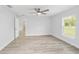Bright bedroom featuring wood-look floors, a ceiling fan, and a window with a view at 800 Marion Oaks Mnr, Ocala, FL 34473