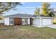 Charming single-story home featuring a well-manicured lawn and a two-car garage at 800 Marion Oaks Mnr, Ocala, FL 34473