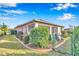 Landscaped backyard with brick edging, green lawn, screened porch, and partial fence for serene outdoor enjoyment at 8245 Sw 78Th Terrace Rd, Ocala, FL 34476