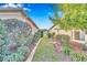 Side yard featuring brick-lined landscaping and lush shrubs between homes, offering a private outdoor space at 8245 Sw 78Th Terrace Rd, Ocala, FL 34476