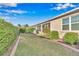Well-manicured backyard with lush landscaping, a brick-lined lawn, and a screened lanai, perfect for outdoor relaxation at 8245 Sw 78Th Terrace Rd, Ocala, FL 34476