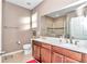 Bathroom with double sinks, wood cabinets, and a glass-enclosed shower at 8245 Sw 78Th Terrace Rd, Ocala, FL 34476