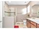 Bright bathroom with a glass-enclosed walk-in shower, neutral color palette, and tile floors at 8245 Sw 78Th Terrace Rd, Ocala, FL 34476