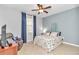 Cozy bedroom with a ceiling fan, and a comfortable chair at 8245 Sw 78Th Terrace Rd, Ocala, FL 34476