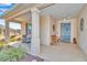 Covered front porch featuring seating area and a decorative front door at 8245 Sw 78Th Terrace Rd, Ocala, FL 34476