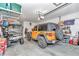 Organized garage with parking space for a car and golf cart plus overhead storage racks at 8245 Sw 78Th Terrace Rd, Ocala, FL 34476