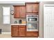 Gourmet kitchen features custom cabinets, built-in microwave and oven at 8245 Sw 78Th Terrace Rd, Ocala, FL 34476