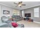 Comfortable living room with leather furniture, ceiling fan, and large windows at 8245 Sw 78Th Terrace Rd, Ocala, FL 34476