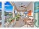 Screened in patio featuring neutral color palette, ceiling fan, and serene backyard views at 8245 Sw 78Th Terrace Rd, Ocala, FL 34476