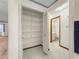 Linen closet with wire shelving and a view into an adjacent bathroom with white vanity at 8519 Sw 91St St # F, Ocala, FL 34481