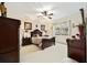 Comfortable bedroom featuring wood furnishings, ceiling fan, and natural light from a window at 8670 Sw 88Th Pl, Ocala, FL 34481