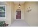 Inviting front entrance with decorative lighting and a traditional-style door at 8670 Sw 88Th Pl, Ocala, FL 34481