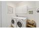 Functional laundry room equipped with washer, dryer, and overhead storage at 8670 Sw 88Th Pl, Ocala, FL 34481