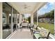Comfortable screened patio with ceiling fan and view of the backyard at 8670 Sw 88Th Pl, Ocala, FL 34481