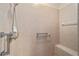 Tiled shower with grab bars and a built-in bench at 8670 Sw 88Th Pl, Ocala, FL 34481