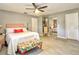 Spacious bedroom with a ceiling fan, a mirrored closet, and neutral walls at 8888 Sw 95Th Ln # D, Ocala, FL 34481