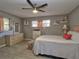Cozy bedroom with a ceiling fan, wood-look flooring, and a dresser with a mirror at 8888 Sw 95Th Ln # D, Ocala, FL 34481