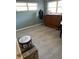 Bright bedroom featuring sleek gray flooring, a window for natural light, and a charming decorative trunk at 8888 Sw 95Th Ln # D, Ocala, FL 34481
