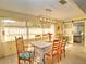 Bright dining room featuring hardwood floors, a modern light fixture, and a glass sliding door to the outdoors at 8888 Sw 95Th Ln # D, Ocala, FL 34481