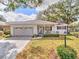 Charming single-story home with a well-manicured lawn, front porch, and attached two-car garage at 8888 Sw 95Th Ln # D, Ocala, FL 34481