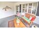 Inviting front porch with charming wicker bench and a small coffee table at 8888 Sw 95Th Ln # D, Ocala, FL 34481