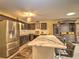 Spacious kitchen with dark cabinets, a large center island, and stainless steel appliances at 8888 Sw 95Th Ln # D, Ocala, FL 34481
