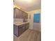Kitchen features modern cabinets, countertops, backsplash, and hardwood-style floors at 8888 Sw 95Th Ln # D, Ocala, FL 34481