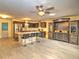 Open kitchen with dark cabinets, center island seating, and modern lighting fixtures at 8888 Sw 95Th Ln # D, Ocala, FL 34481