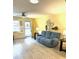 Inviting living room featuring a comfortable blue sofa and ample natural light from the windows at 8888 Sw 95Th Ln # D, Ocala, FL 34481