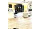 Living area featuring dark entertainment center and breakfast bar with modern seating at 8888 Sw 95Th Ln # D, Ocala, FL 34481