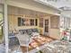 Covered patio featuring outdoor seating and a stone-paved floor at 8888 Sw 95Th Ln # D, Ocala, FL 34481