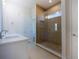 Bathroom featuring double sinks, spacious shower with accent tiles, and a separate toilet room at 9594 Se 61St Ter, Belleview, FL 34420