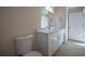 Bathroom featuring a single sink vanity, neutral paint, and a toilet at 9594 Se 61St Ter, Belleview, FL 34420