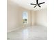 Bright bedroom featuring a ceiling fan and large window, complete with sleek marble floors at 9594 Se 61St Ter, Belleview, FL 34420