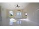 Open-concept living area boasts sleek marble floors, recessed lighting and a large arched window for natural light at 9594 Se 61St Ter, Belleview, FL 34420