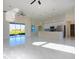 Expansive living space with marble floors seamlessly connects to the modern kitchen and backyard patio at 9594 Se 61St Ter, Belleview, FL 34420