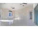 Spacious living room with marble floors, recessed lighting, ceiling fans, and arched double-door entryway at 9594 Se 61St Ter, Belleview, FL 34420