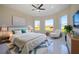 Serene main bedroom features tray ceilings, ample natural light, and a cozy sitting area for relaxation at 9594 Se 61St Ter, Belleview, FL 34420