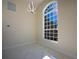 Bright room with large window, contemporary chandelier, marble floors, and neutral color scheme at 9594 Se 61St Ter, Belleview, FL 34420