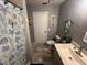 This is a bathroom with gray walls, with a tiled floor, a toilet, and a sink with decor at 1008 Se 26Th St, Ocala, FL 34471