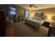 Spacious bedroom features a ceiling fan, soft lighting, a queen bed, and beach-themed decorations at 1008 Se 26Th St, Ocala, FL 34471