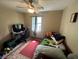 Bedroom featuring a bed, lots of personal items, ceiling fan, a rug and a window at 1008 Se 26Th St, Ocala, FL 34471
