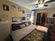 Bedroom with a ceiling fan, a bed with many pillows, closet, and an air conditioner at 1008 Se 26Th St, Ocala, FL 34471