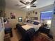 Well-lit bedroom featuring a ceiling fan, window with blinds, and a comfortable-looking bed at 1008 Se 26Th St, Ocala, FL 34471