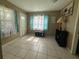 Bonus room featuring tiled floors, an exterior door with doggie door, and neutral color scheme at 1008 Se 26Th St, Ocala, FL 34471