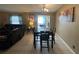 Inviting dining area featuring tile floors, neutral walls, and a chandelier with adjacent sitting area at 1008 Se 26Th St, Ocala, FL 34471