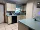 Traditional kitchen with black appliances and dated wallpaper at 1008 Se 26Th St, Ocala, FL 34471