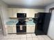 Kitchen featuring black appliances and dated, light countertops at 1008 Se 26Th St, Ocala, FL 34471