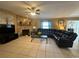 Large living room with a stone fireplace, tile flooring, and comfortable seating at 1008 Se 26Th St, Ocala, FL 34471